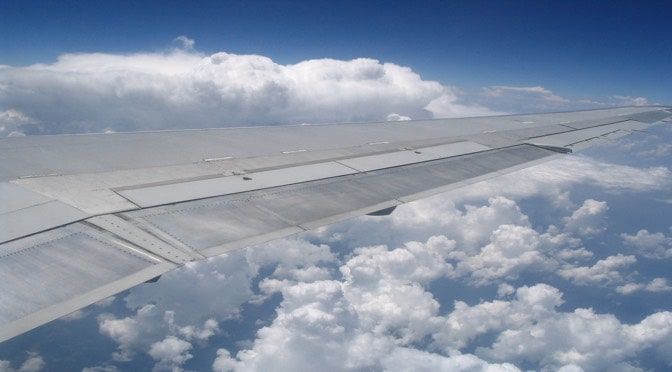 Airplane wing amongst the clouds