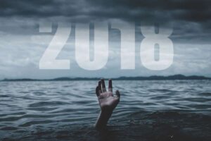 A hand reaching out for the word 2018
